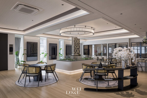 SevenCo sales gallery by Bronhaus with a central development model and circular pendant light