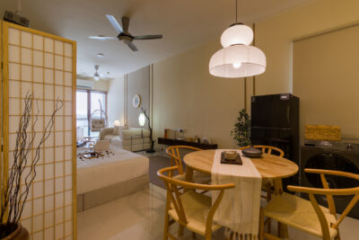 Open-plan dining and living area at FIVE SENSES – KIP CORE showcasing warm lighting and cohesive interior styling.