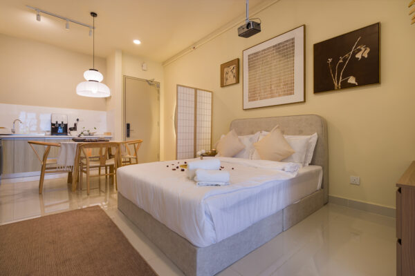 Open-plan dining and living area at FIVE SENSES – KIP CORE showcasing warm lighting and cohesive interior styling.