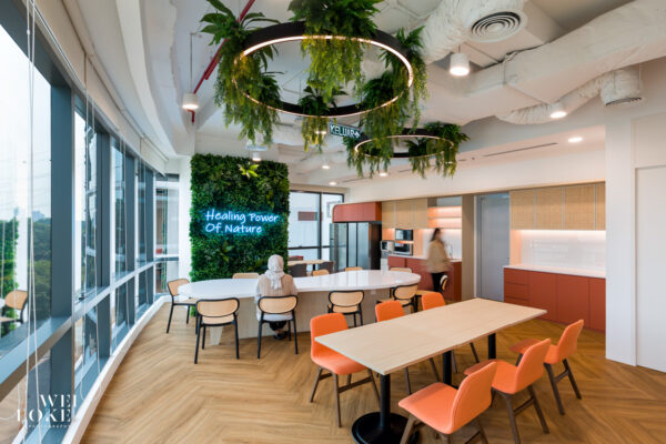 Office pantry with bar seating, pendant lighting, and warm wood finishes in Blackmores office.