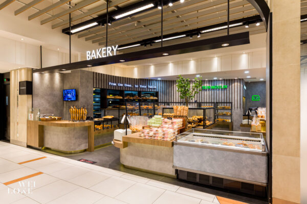 Interior view of Sun Moulin bakery at KLCC with dark-toned materials and ceiling slats.