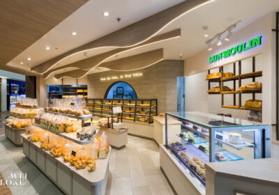 Sun Moulin’s fresh bakery section bathed in warm lighting and modern wood-accented design.