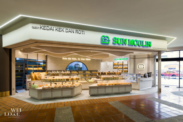 Exterior view of Sun Moulin bakery with visible signage and full product display.