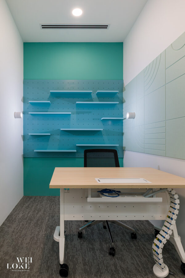 Workspace with display wall and ceiling lights, designed for video meetings in Blackmores Malaysia.